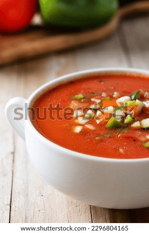 Traditional Spanish gazpacho soup in bowl on wooden table. Close up Royalty-Free Stock Photo #2296804165