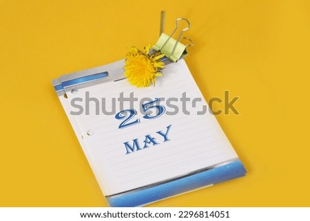 Calendar for May 25: desk calendar with yellow dandelion, number 25, name of the month May in English
Walk with Mary.
