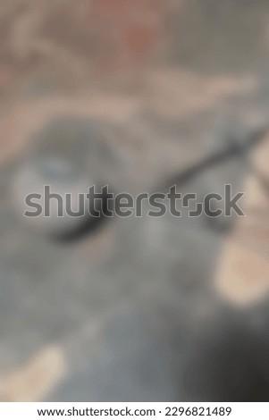 Blur photo of black frame glasses, and stone on cement floor