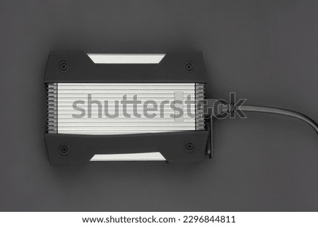 External USB hard drive isolated on white background. Waterproof protected external hard drive. Hard disk for connecting to a laptop, transferring data between a computer and a hard disk.