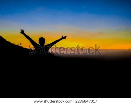 silhouette photo of person spreading arms in nature