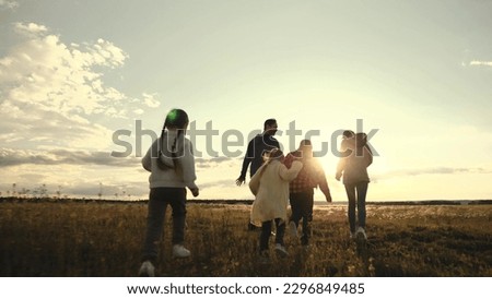 Child Father Mother Running Sunset Park. Happy Family Park. Airplane Pilot Game. Silhouette happy family running park rays sunlight. teamwork. Group of children running sunset grass field. Concept