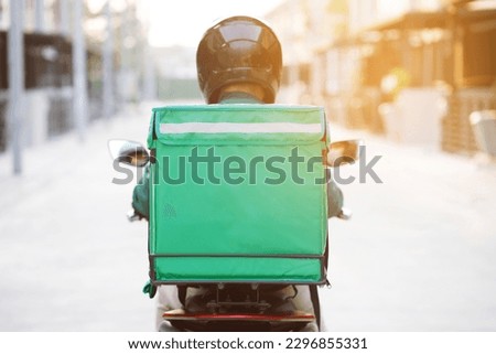 green shirt rider Ready for fast food delivery with online applications Royalty-Free Stock Photo #2296855331