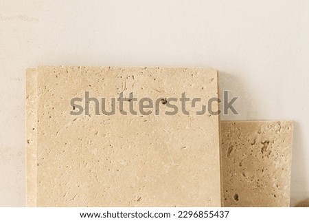 Travertine tiles against gypsum plaster wall. Construction of house and home renovation concept. Stylish natural travertine stone tile close up Royalty-Free Stock Photo #2296855437