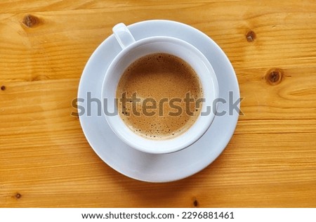 cup of black coffee on wooden table, natural colors
