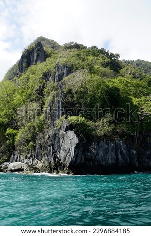 massive limestone rocks in the blue sea at the el nido archipelago