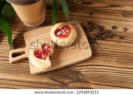 Appetizing cookies with hearts and a glass of coffee on a wooden background. Photo for a website with cooking recipes.