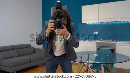 Milan Man  professional Photographer real estate taking  videos and photos of interior of houses for sale - home staging in the kitchen blue wall living room -  photographic  shooting  indoor at home 