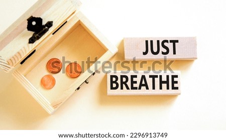 Just breathe and psychological symbol. Concept words Just breathe on wooden block. Beautiful white table white background. Wooden chest coins. Business psychological Just breathe concept. Copy space