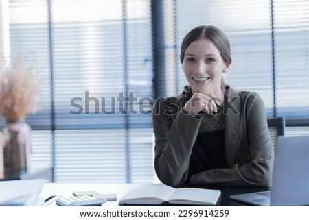 happy young businesswoman  American siting on the chair cheerful demeanor raise smiling looking laptop screen.Making opportunities female working successful in the office