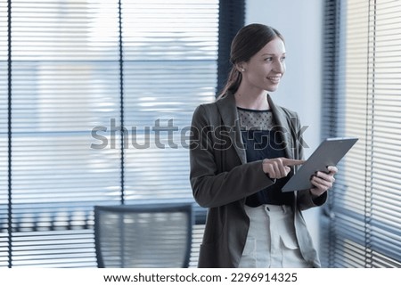 happy young businesswoman  American siting on the chair cheerful demeanor raise smiling looking laptop screen.Making opportunities female working successful in the office
