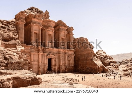 The monastery in the ancient city of Petra on a sunny summer day and tourists wide angle photo