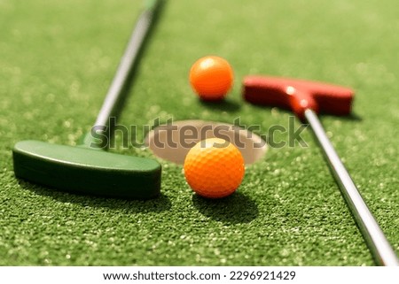 Mini-golf ball on artificial grass. Summer season game Royalty-Free Stock Photo #2296921429