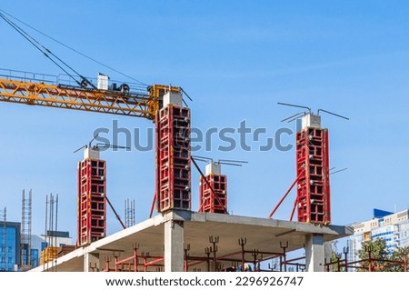 Supports on reinforced concrete piles and a frame during the construction of a multi-storey building. Reinforcement of reinforced concrete columns. The formwork of columns. Construction technology. Royalty-Free Stock Photo #2296926747