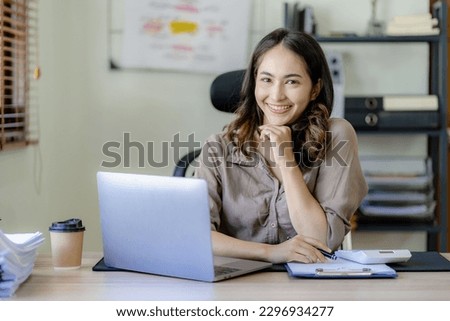 Beautiful Asian businesswoman working from home with tablet computer, small business owner, freelancer online marketing sme ecommerce marketing concept