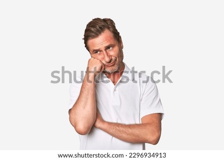A middle-aged man isolated who feels sad and pensive, looking at copy space. Royalty-Free Stock Photo #2296934913