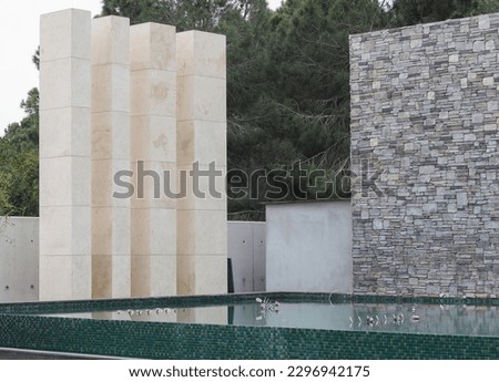 gray stone wall with swimming pool