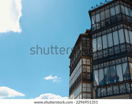 Stylish vintage balconies made of metal and wood seen from outside in Segovia, Spain.