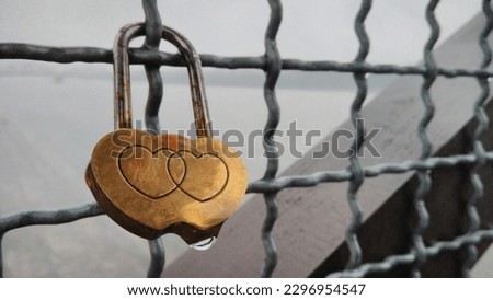 a single love lock hanging in the bridge over Vistula River, Toruń Poland.