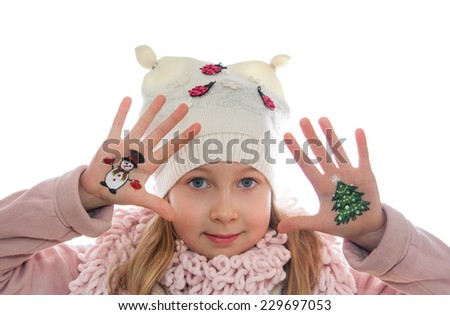 Happy girl demonstrating Christmas symbols painted on her hands. Snowman and Christmas tree 