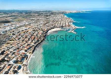 Torre de la Horadada aerial shot, drone point of view of Mediterranean Seascape and townscape view. Travel destinations and holiday concept. Costa Blanca. Spain