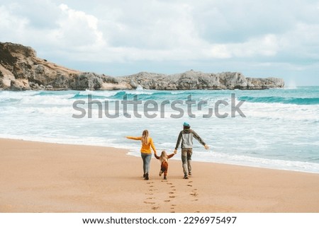 Family mother and father with child walking together outdoor travel lifestyle vacations parents with kid holding hands on the beach happy emotions sea landscape