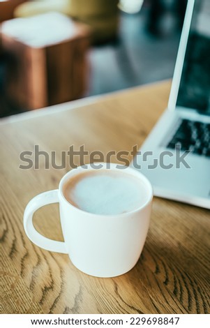 Coffee cup , laptop in coffee shop - vintage effect style pictures