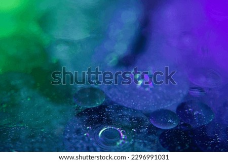 Circles on the water. Oil stains. Spilled fuel. Oil in water. Gasoline in water. Liquid like oil. Bubbles in the water of different colors and sizes. Red, blue, purple and green.