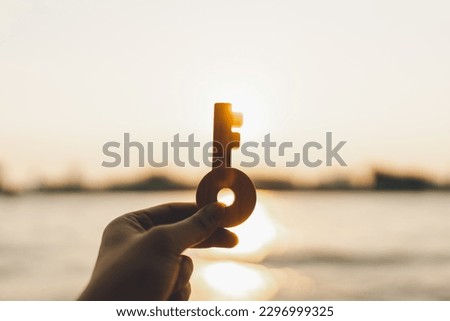Businessman holding key model. Key of Success business concept. businessman looking forward. Royalty-Free Stock Photo #2296999325