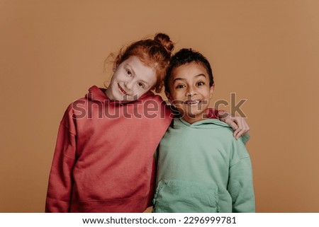 Boy with his friend posing during studio shoot. Royalty-Free Stock Photo #2296999781