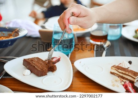 Symbolic image of human hands enjoying a scrumptious breakfast dessert of bread and berries, representing the simple pleasures of life and the importance of savoring every moment
