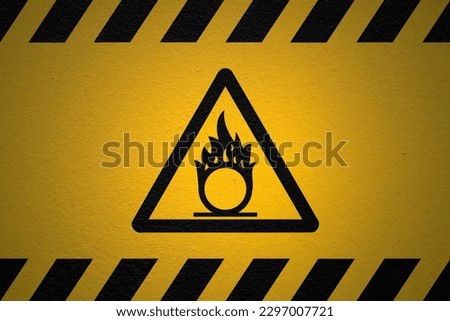 Black striped yellow background with a Self ignition warning sign and a light effect to dramatize the whole.