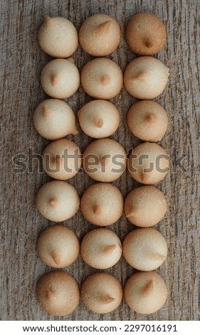 Mini Milk Biscuits Ae Laid Out In Three Even Rows On A Vintage Wooden Board Vertical Stock Photo For Bakery Backgrounds 
