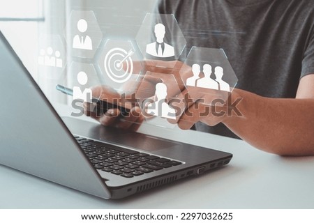 Target audience concept. Businessman click on target button on virtual screen to focus customer group. Marketing plan and strategies. Personalization marketing, customer centric strategies. Royalty-Free Stock Photo #2297032625
