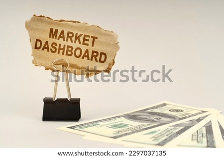 Business and finance concept. There is money on the table, next to it is a cardboard sign with the inscription - Market Dashboard