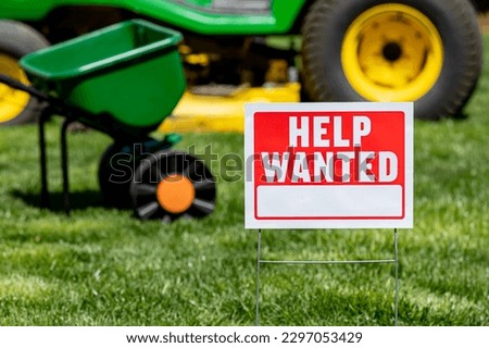Help wanted sign for lawn care and mowing work. Labor shortage, trade jobs market and employment concept