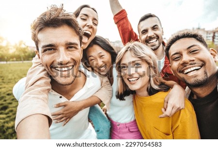 Multiracial friends taking selfie picture with smart mobile phone outside - Group of young people smiling at camera outdoors - Friendship concept with guys and girls enjoying summer vacation 