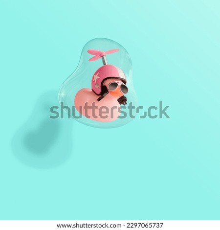 Creative composition made of pink cute little rubber duckling with a helmet and sunglasses floating in a soap bubble. Contemporary style.Creative art minimal aesthetic, minimal abstract concept