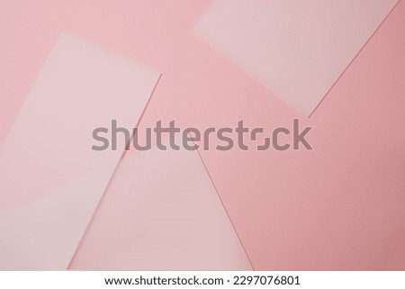Against a light pink background, several acrylic sheets are arranged with blank space for product or goods presentation. Copy space