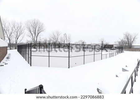 winter tennis court full of snow