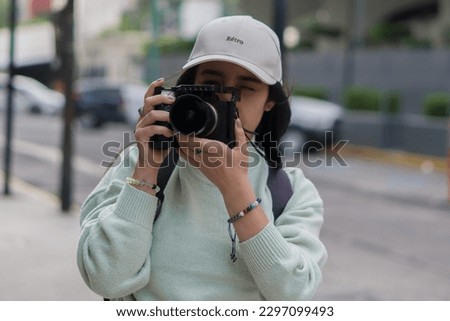 A woman taking street photographs 