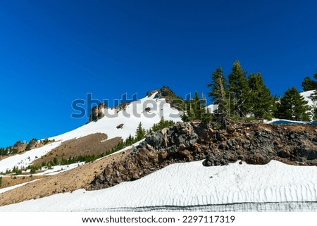 White snow field in Crater Lake National Park, Oregon on a sunny day Royalty-Free Stock Photo #2297117319