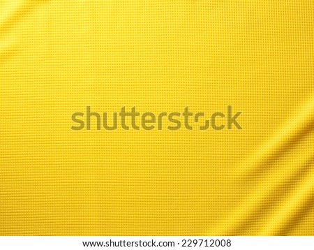 Sport Clothing Fabric Texture Background. Top View of Cloth Textile Surface. Yellow Football Shirt. Text Space Royalty-Free Stock Photo #229712008
