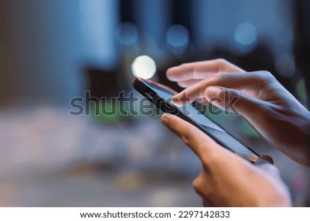 Close-up male hand using smartphone at meeting room blur bokeh background. searching data networks or chatting online. typing sending message. mockup mobile phone wireless. 