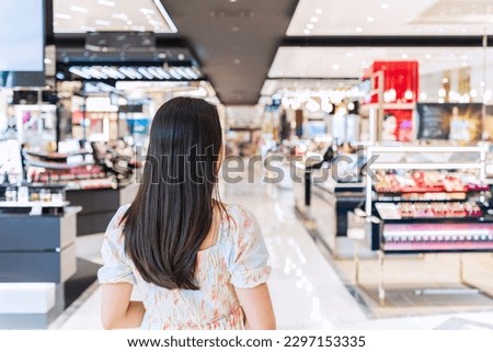 Young woman shopping in cosmetics department store at the mall, Lifestyle concept