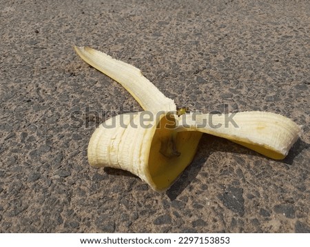 The banana peel after eating was thrown on the floor.