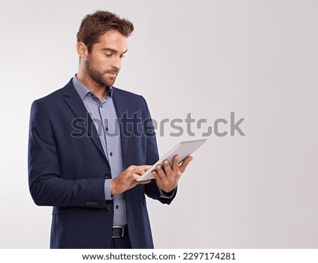 Business man with tablet, technology or corporate communication isolated on studio background. Internet, connectivity or networking professional, male worker or check email for career on mockup space Royalty-Free Stock Photo #2297174281