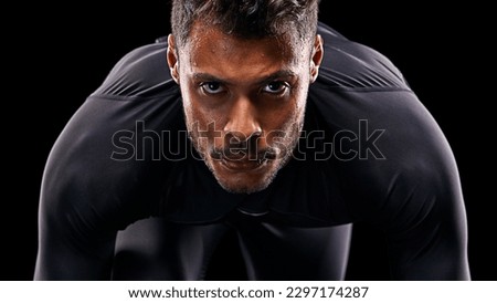 Portrait, isolated runner and man ready to run, start race and intense focus in dark studio background. Serious, man and running or athlete, cardio or training motivation to win, workout or exercise