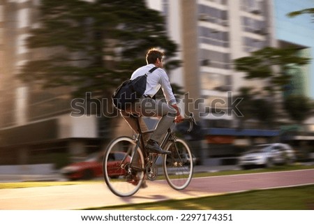 Fast, bicycle and business man in city for morning, commute and carbon neutral transportation. Travel, sustainability and cycling with male employee in urban town for motion blur, speed and transit Royalty-Free Stock Photo #2297174351