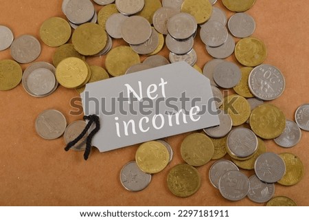 Bunch of coins with text NET INCOME. Net income is the amount of money a company earns after subtracting all of its expenses from its total revenue during a specific period of time Royalty-Free Stock Photo #2297181911